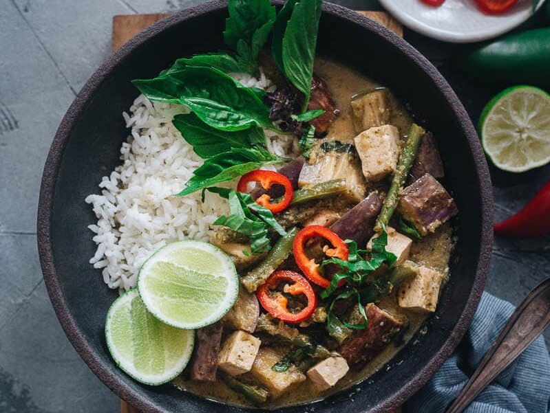 green thai curry on a dark bowl.