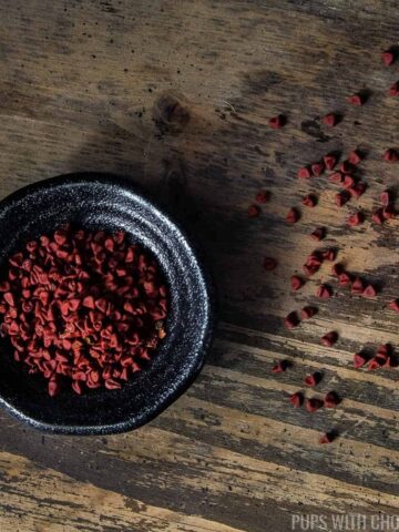 annatto seeds scattered on a wooden table