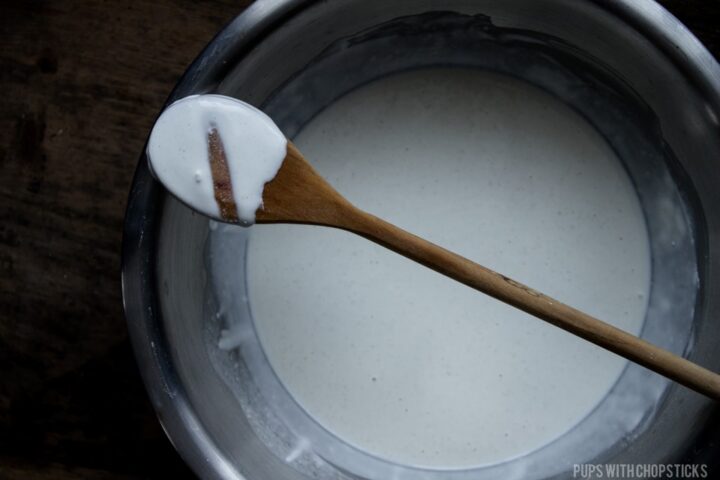 Rice flour batter on a back of a wooden spoon to show how thick the batter should be.