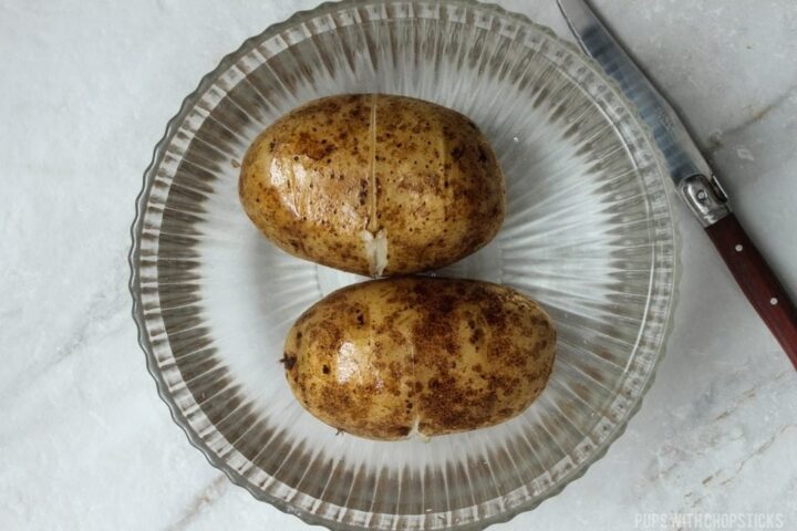 Make a slit around the potato and put it in cold water.