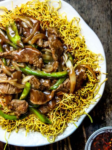 Cantonese Beef Chow Mein on a white plate on a wooden table
