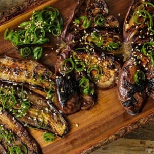 Miso eggplant fanned out on a wooden plate