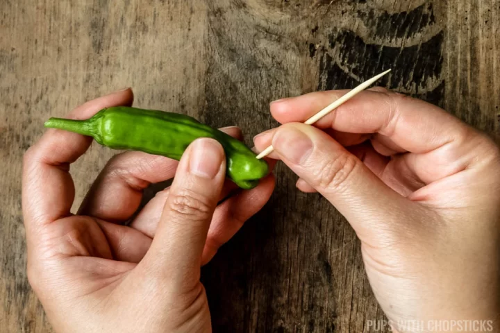 Puncturing shishito peppers with toothpick