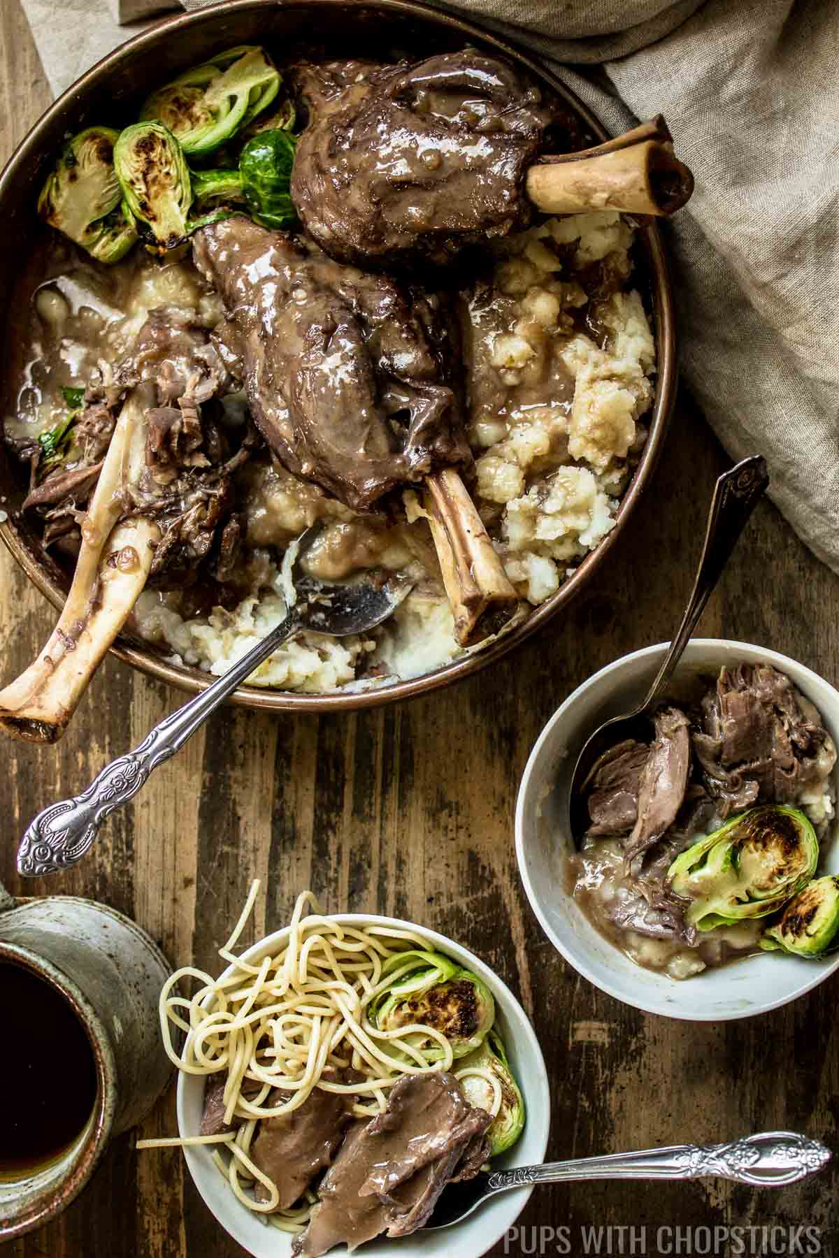 Braised lamb shanks with red wine, and miso served with brussel sprouts and mashed potatoes and pasta