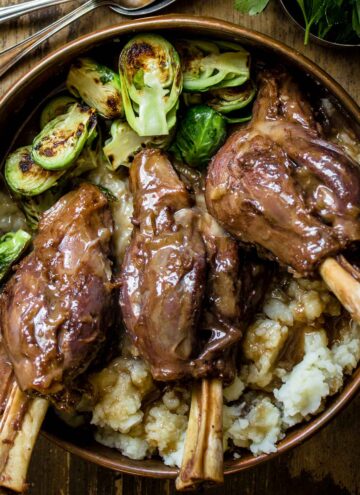 Closeup of Braised lamb shanks with red wine, and miso served with brussel sprouts and mashed potatoes