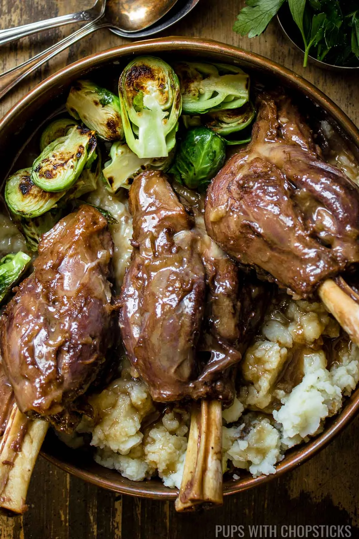 Braised lamb shanks with red wine, and miso served with brussel sprouts and mashed potatoes.