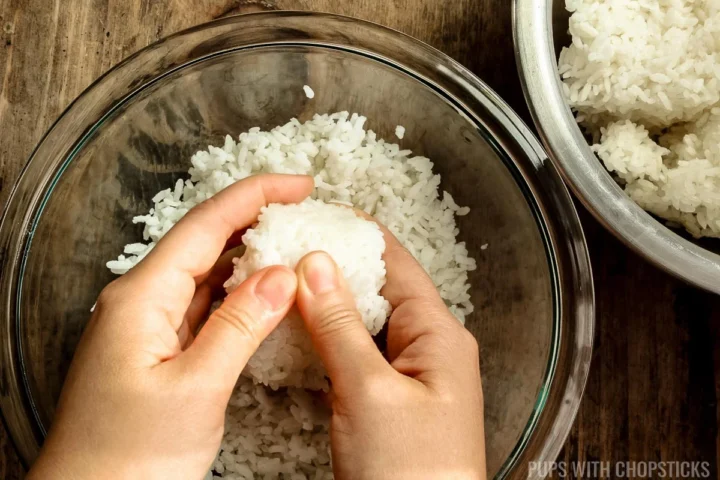 Breaking chunks of rice by hand into individual grains for fried rice.