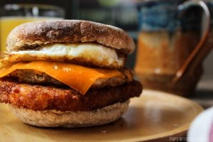 A side profile of breakfast sandwich to show the stack of ingredients 