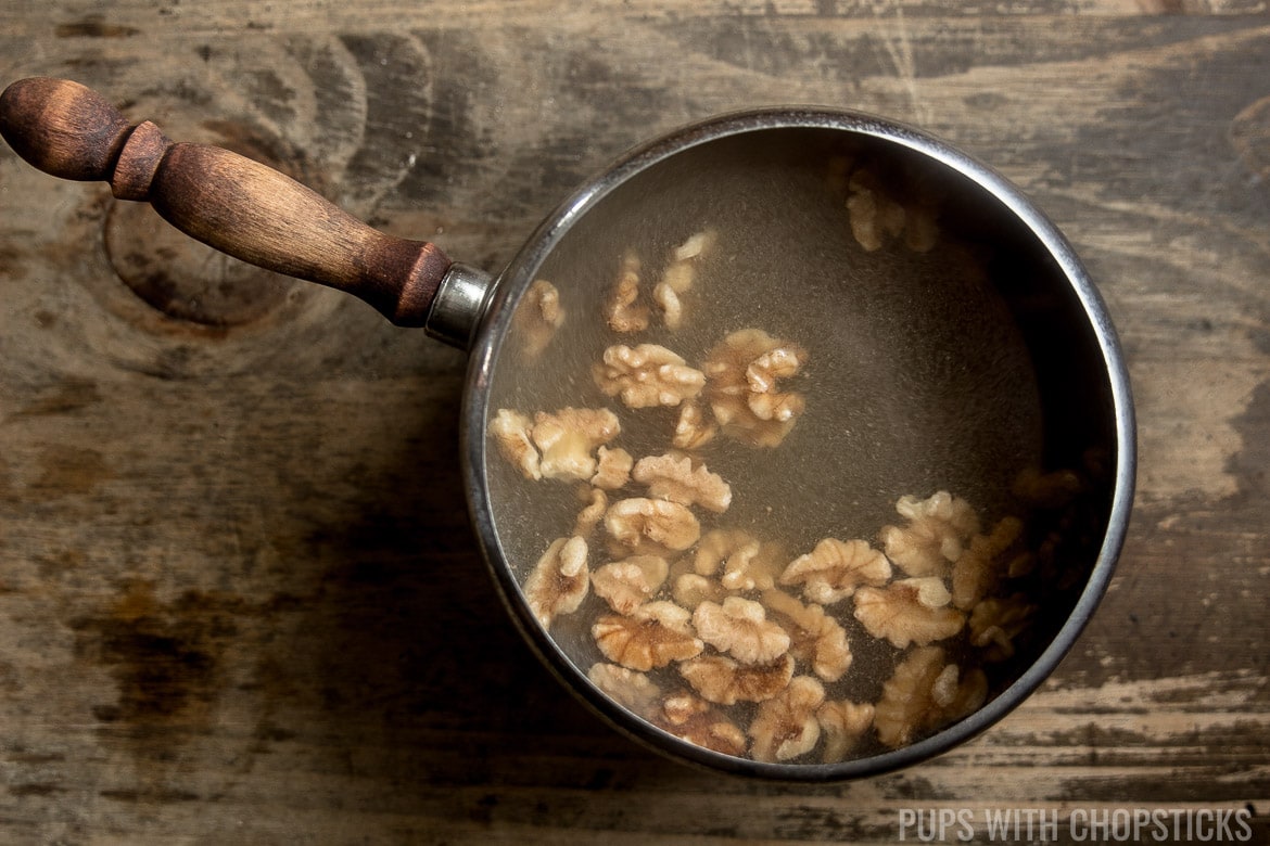 Walnuts floating in a boiling pot of water