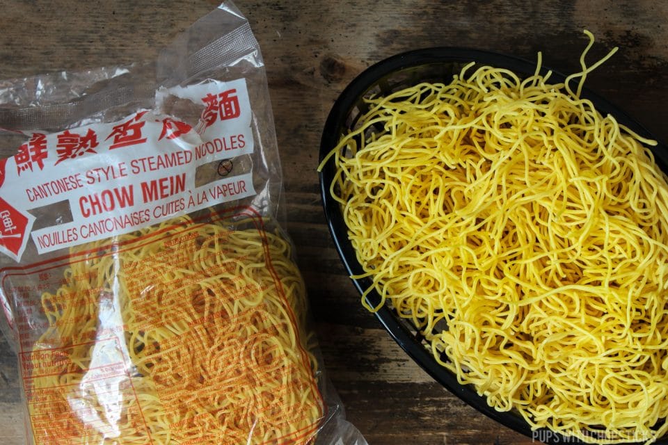A bag of Cantonese chow mein in a black basket