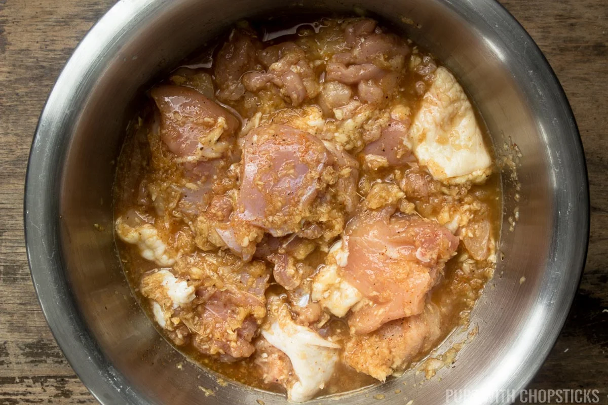 Boneless chicken being marinated in ginger garlic and spices in prep for manchurian chicken.