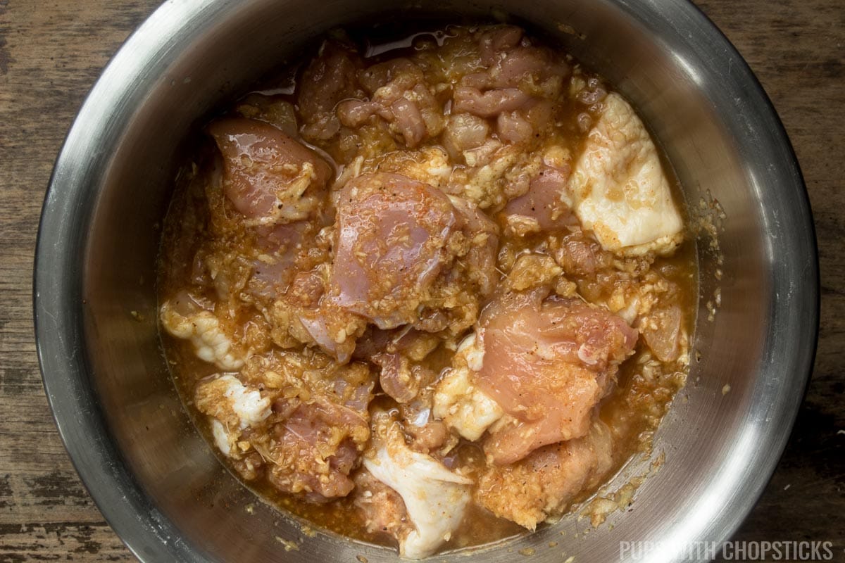 Boneless chicken being marinated in ginger garlic and spices in prep for manchurian chicken.