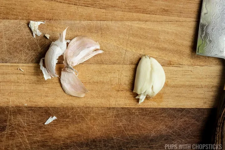 Garlic being smashed in prep for Chinese brown sauce.