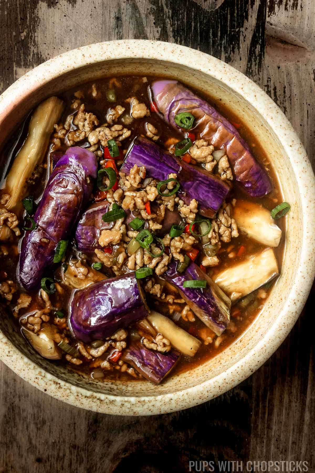 Overhead closeup picture of Chinese eggplant with garlic sauce in a large bowl