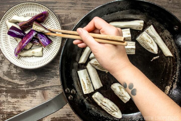 Removing eggplants from pan, once it has pan-fried and 'steamed' in the frying pan once it is soft