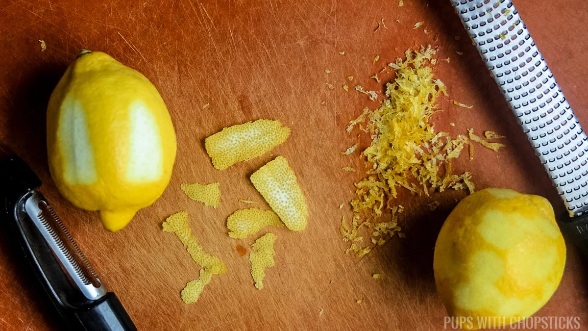 Lemons being zested with a micro planer, and using a vegetable peeler to show the difference.