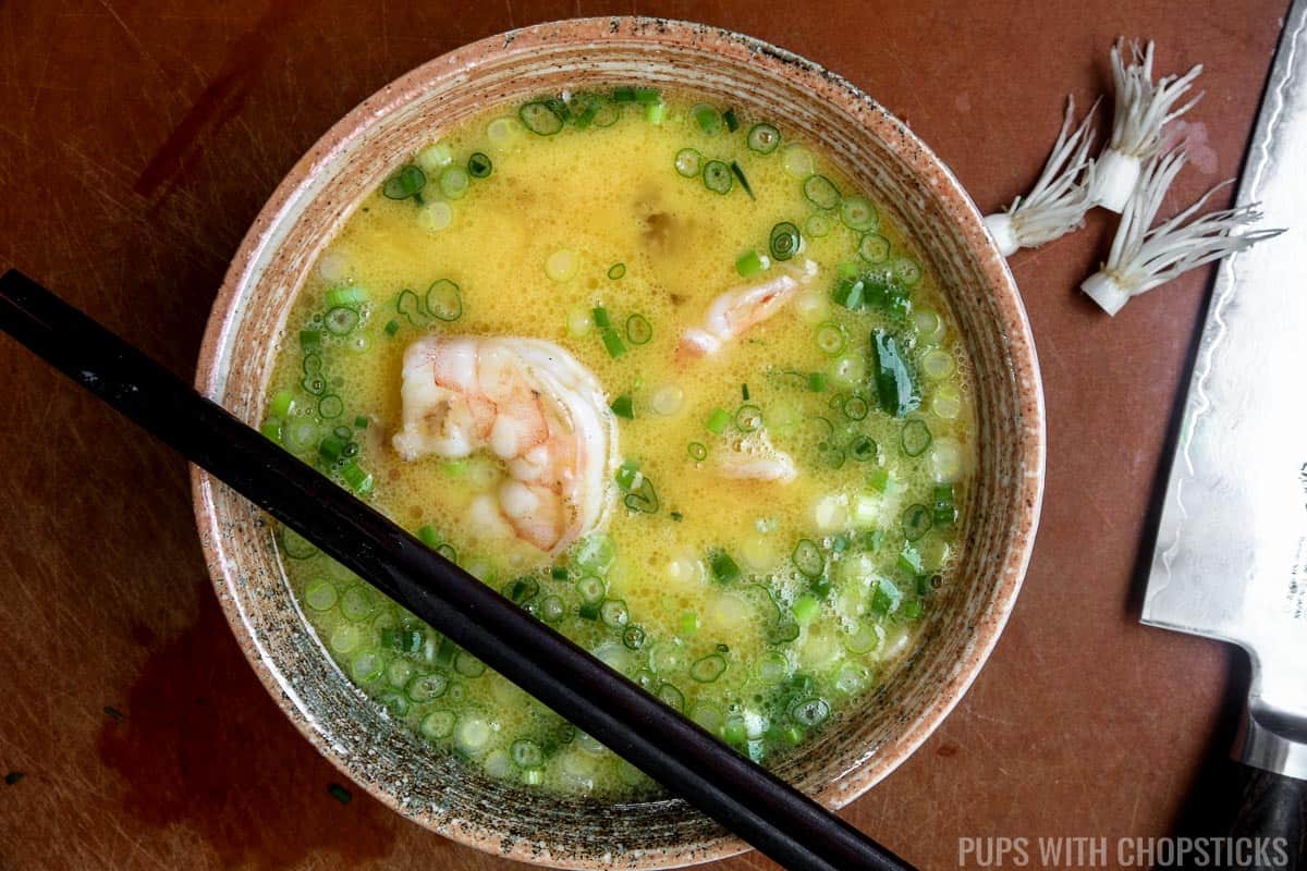 Raw egg mixture with green onions, cooked shrimp and salt