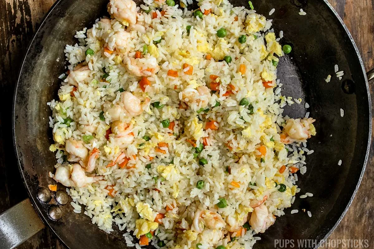 chinese shrimp fried rice finished cooking in a frying pan.