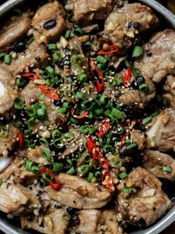 close up of Chinese Steamed Spare Ribs garnished with green onions and sesame seeds
