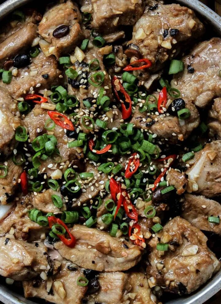 close up of Chinese Steamed Spare Ribs garnished with green onions and sesame seeds