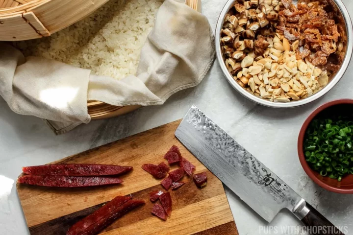 Chinese sausage being chopped on a cutting board