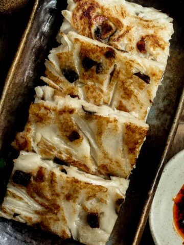 Plate of traditional Chinese turnip cake (lo bak go) served with chili oil
