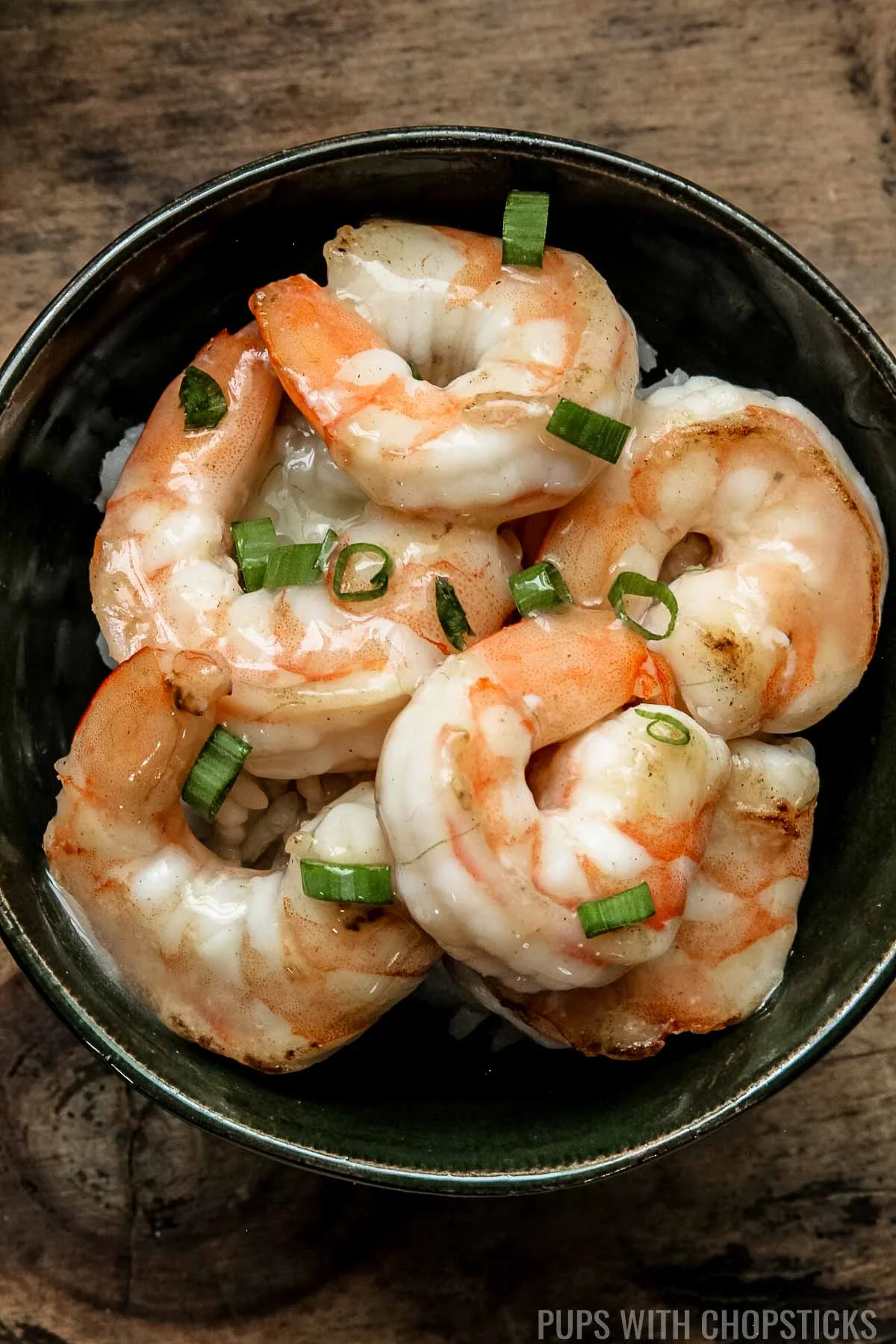 Shrimp with Chinese white sauce tossed on it served with rice.