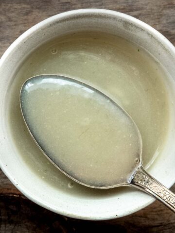 Chinese white sauce on a spoon in a white bowl.