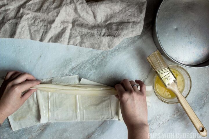 pinching the phyllo pastry into a strip.