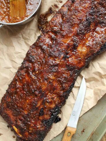 A slab of coca cola ribs on parchment.
