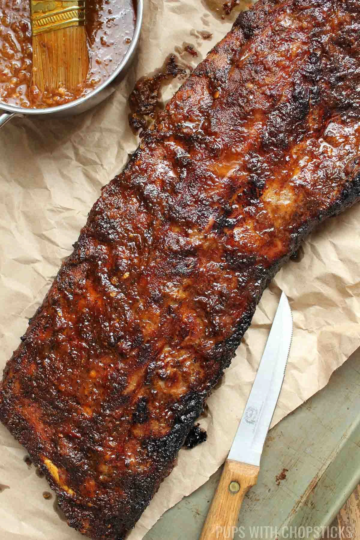 A slab of coca cola ribs on parchment.