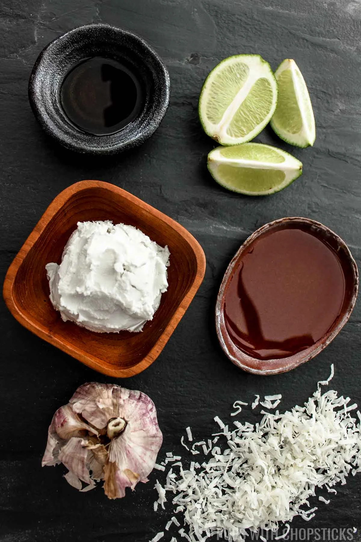 Creamy Coconut Dip ingredients on a table (coconut cream, lime juice, garlic, fish sauce, honey)