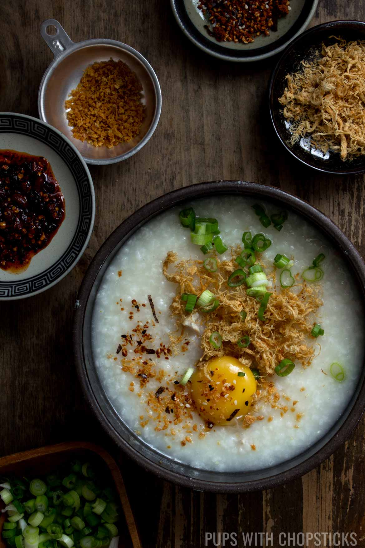 Congee topped with egg yolk, pork floss, green onions and furikake