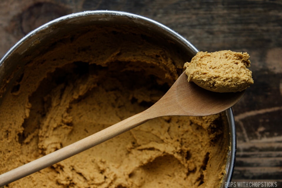 Ginger Molasses Cookies cookie dough on a wooden spoon to show the consistency of the batter.