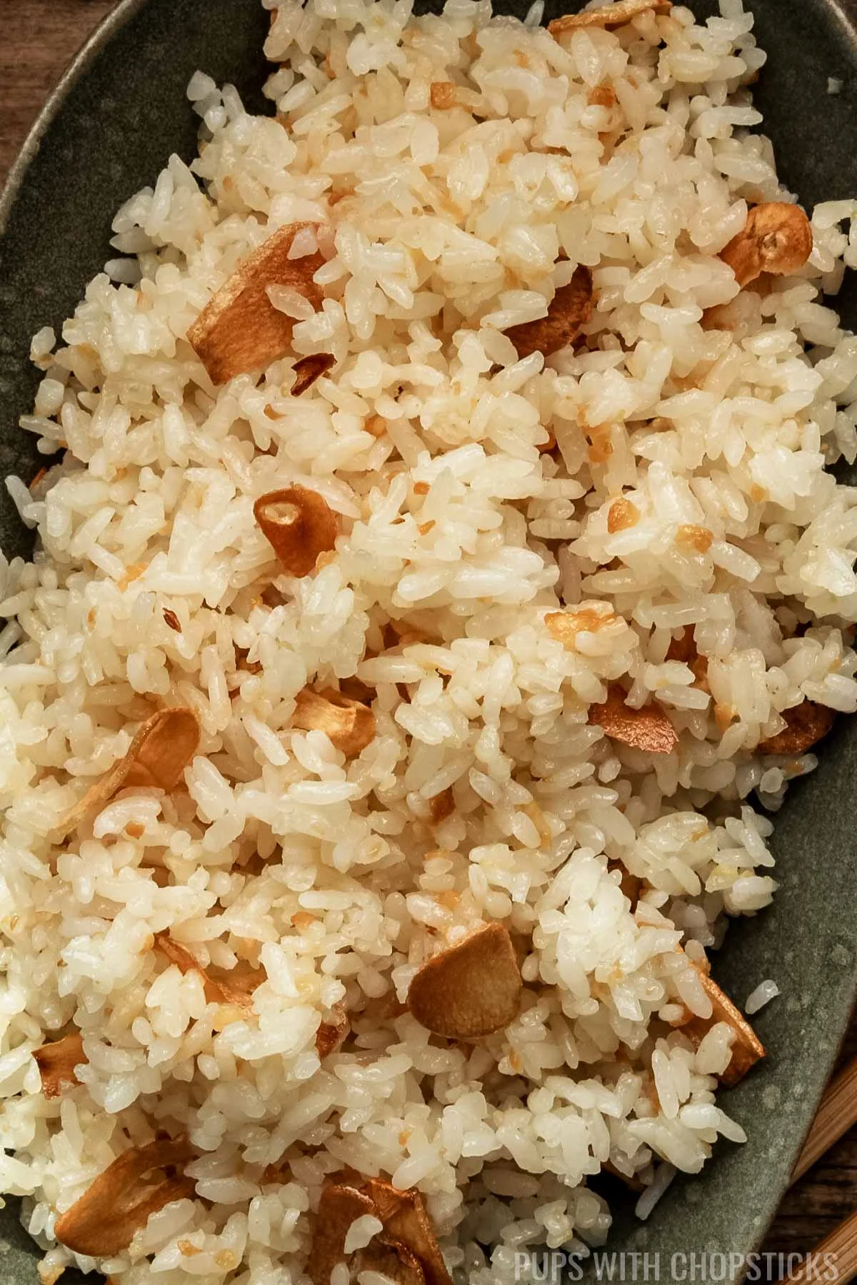 Closeup of Filipino garlic Fried Rice (Sinangag) in a green bowl