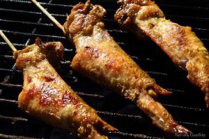 Chicken Satay Wings being grilled over the bbq