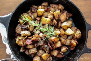 Skillet Potatoes Infused with Caramelized Onions in a cast iron pan