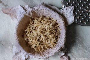 Raw grated potatoes that have been dried out from being wrung with a dry towel, for the crispy hash browns