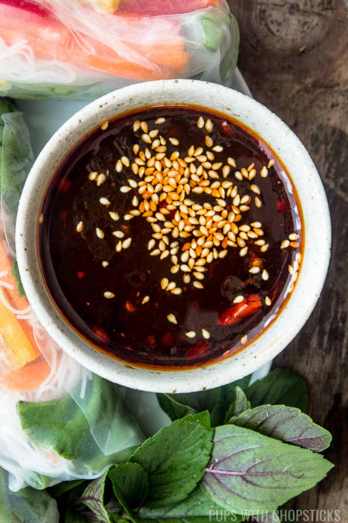 A close up of hoisin dipping sauce served with Vietnamese rice paper rolls (summer rolls)