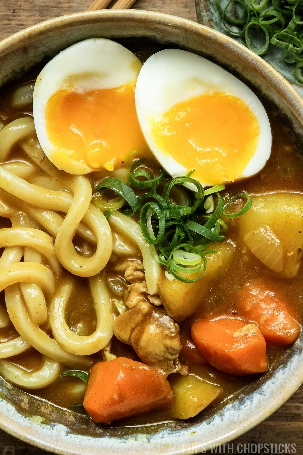 Close up of Japanese curry udon served with soft boiled egg