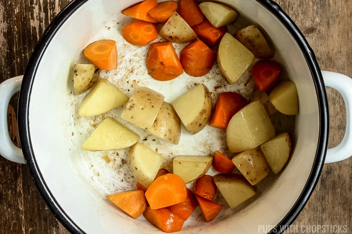 Cooking potatoes and carrots in a large pot