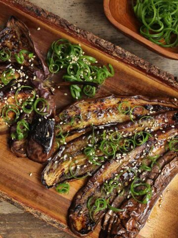 Miso eggplant fanned out on a wooden plate