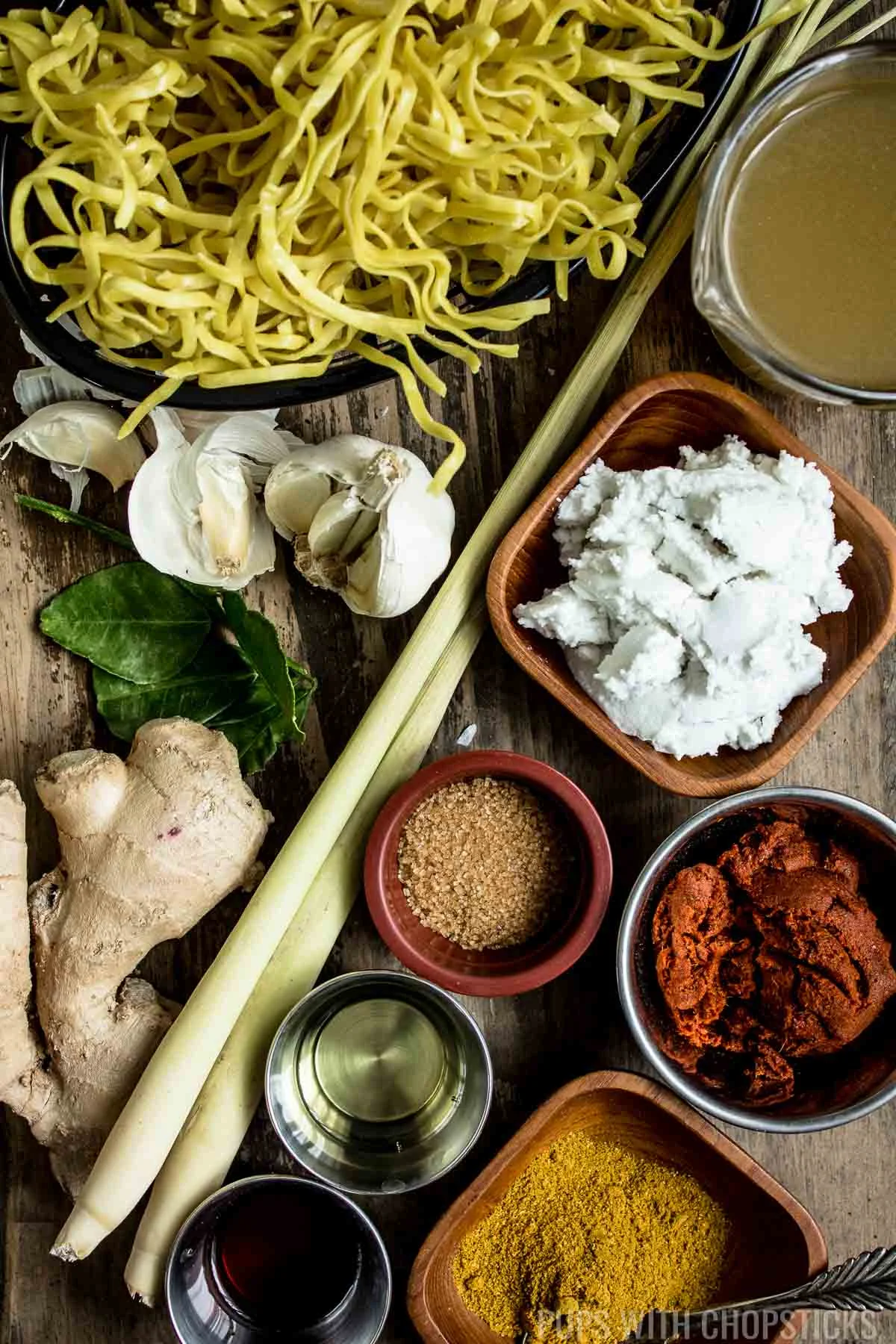 Khao soi (Thai Coconut Curry Noodle Soup) Ingredients laid out on the table
