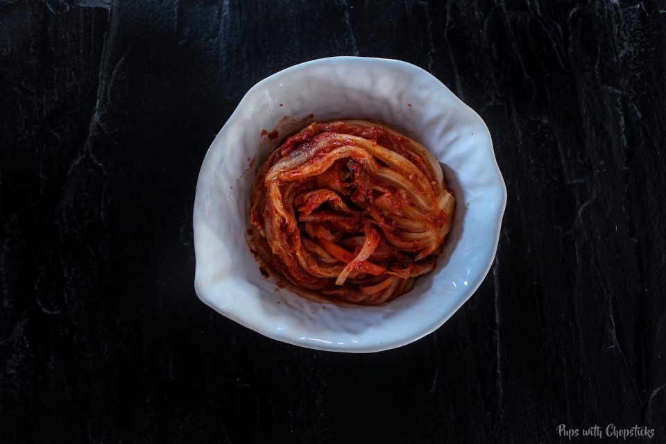 A bowl of kimchi on the counter