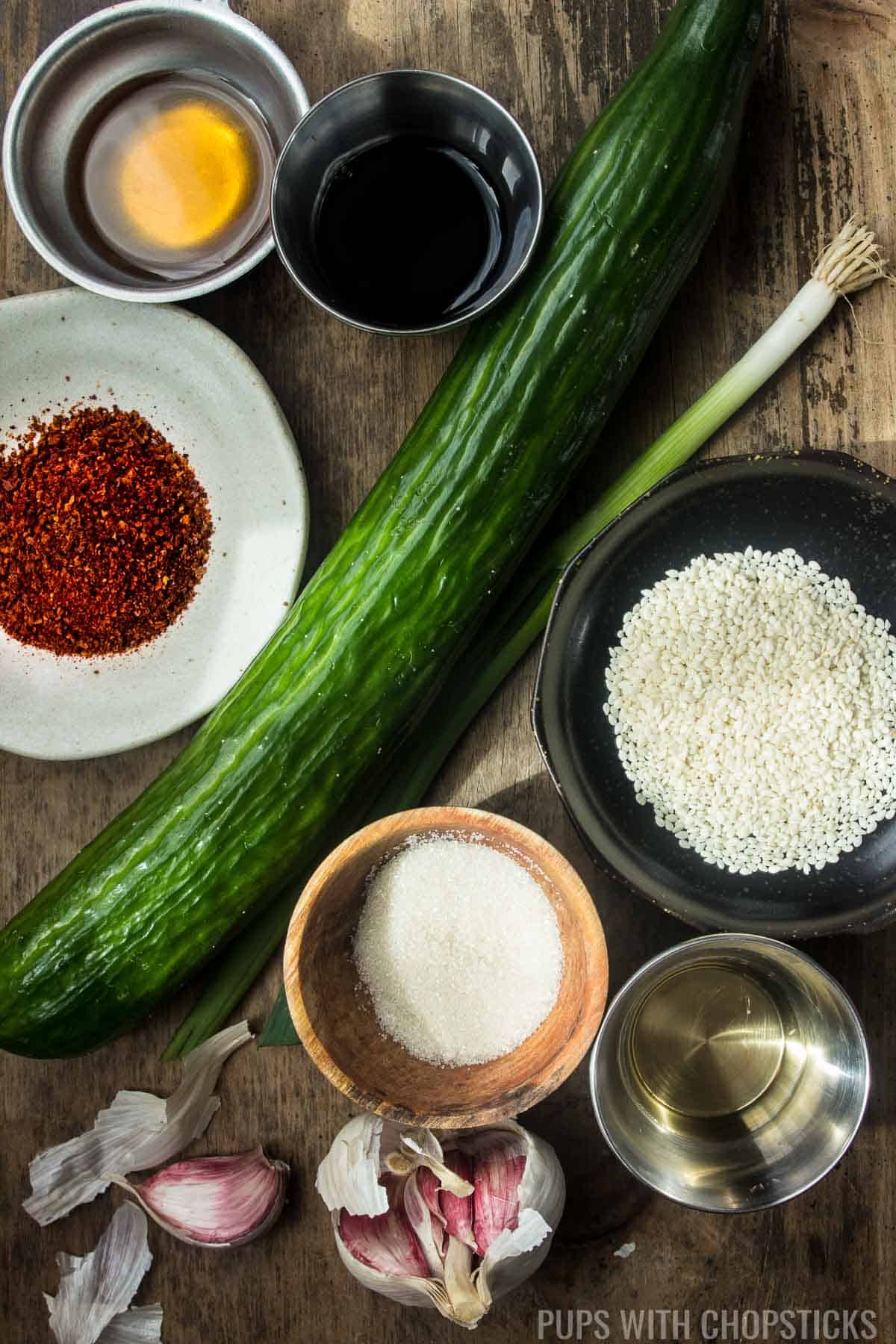 Ingredients for Korean cucumber salad (cucumber, gochugaru, green onion, soy sauce, sesame oil, toasted sesame seeds, sugar, rice vinegar and garlic)