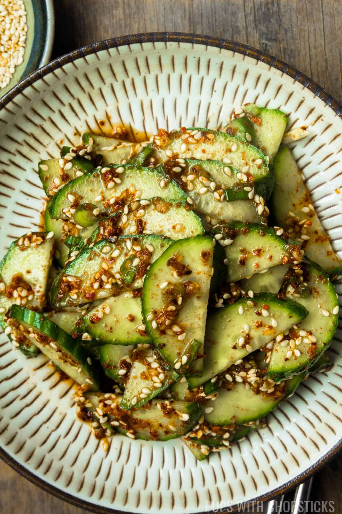 Close up of Korean cucumber salad (oi muchim) on a beige plate.