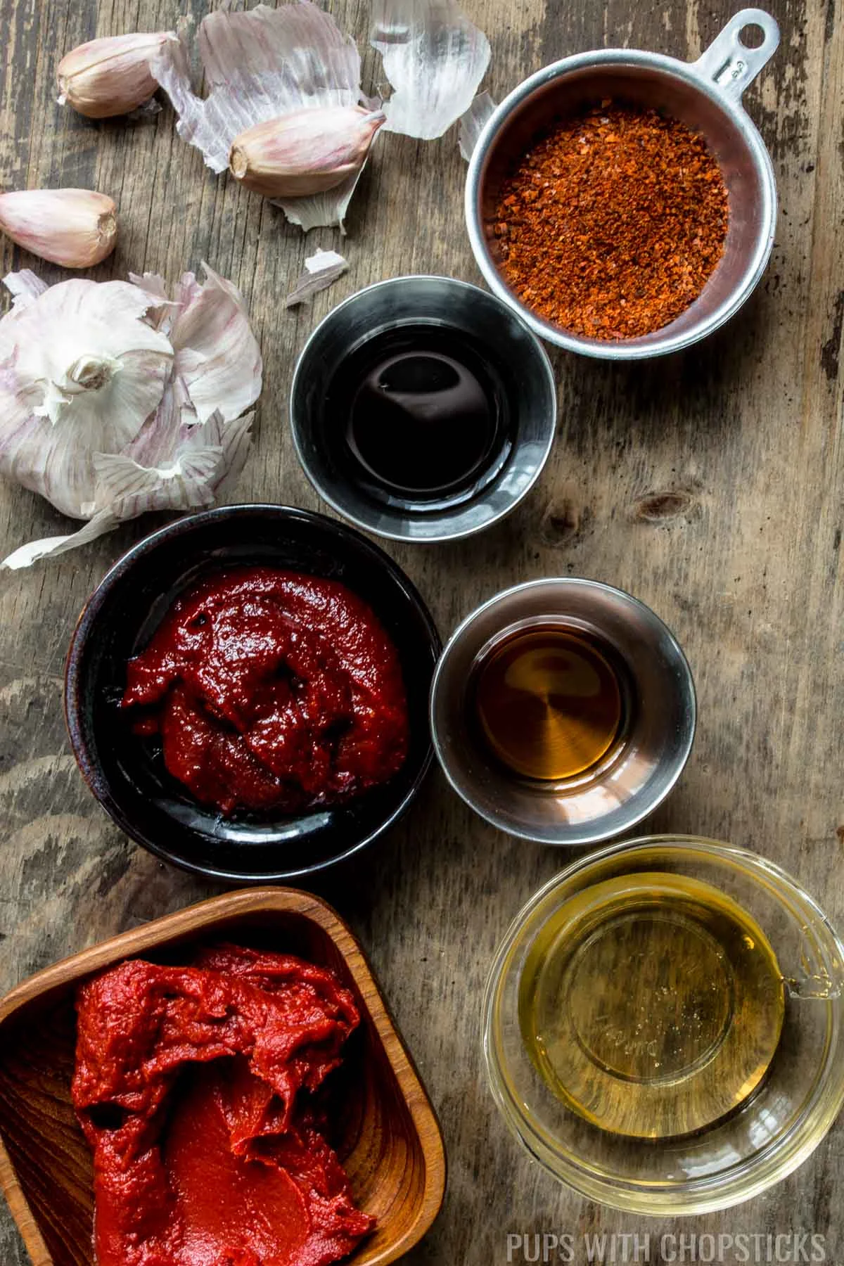 Ingredients for Sweet and Spicy Gochujang sauce (tomato paste, gochujang, honey, sesame oil, soy sauce, garlic, chilli flakes)