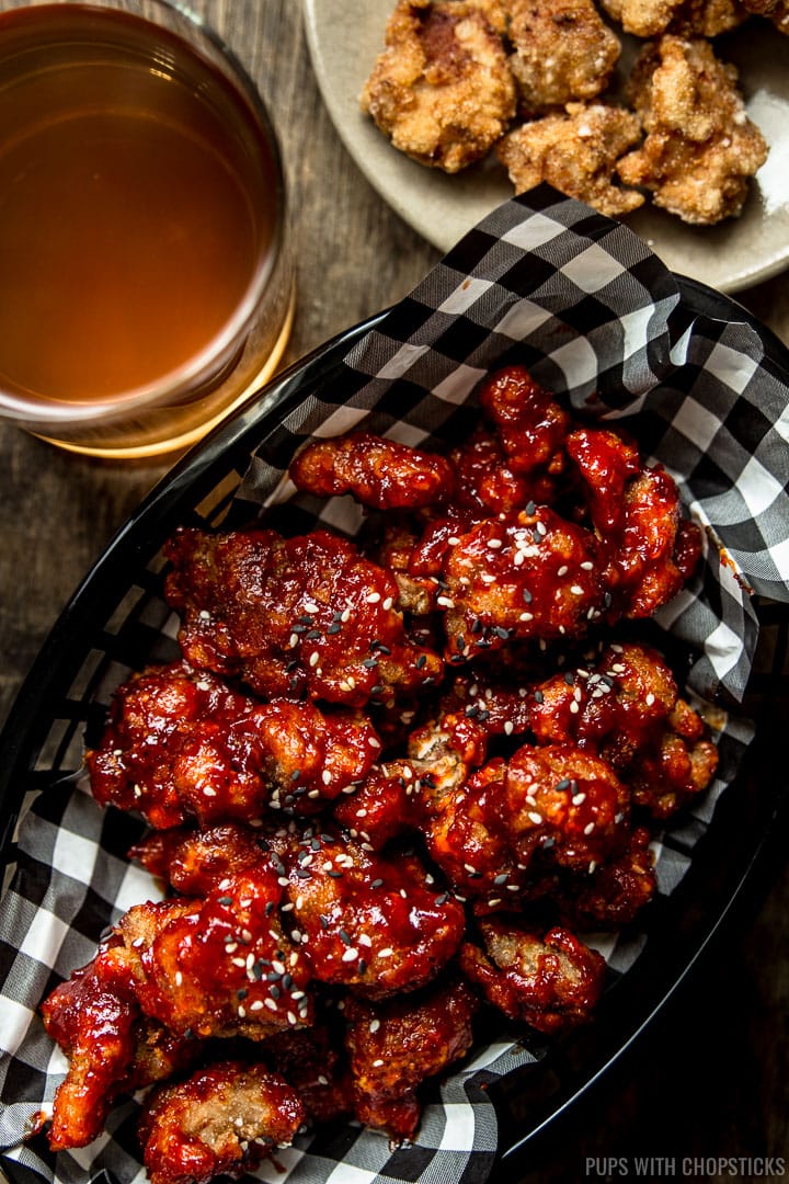A basket of Korean fried popcorn turkey coated with a red sweet and spicy gochujang sauce