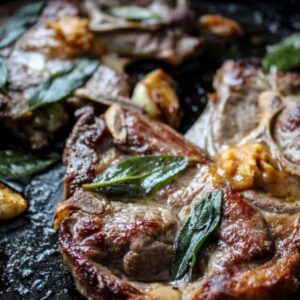Pan fried lambchops in a cast iron pan with miso butter