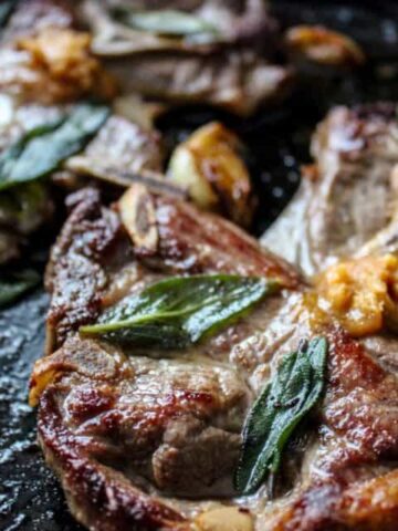 Pan fried lambchops in a cast iron pan with miso butter